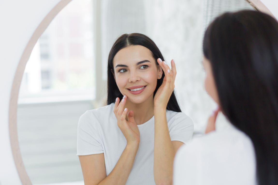 After a Chemical Peel woman looking at herself in the mirror